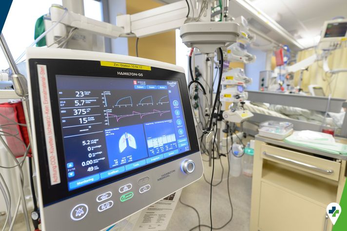 Monitor auf der Intensivstation, links unten das Icon zur Veranstaltungsreihe "Medizin im Dialog"